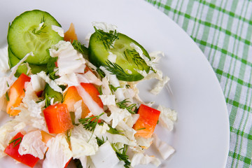 White plate with fresh vegetable salad