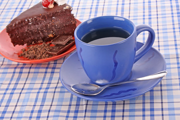 Slice of chocolate cake and cup of tea