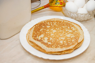 Plate with pancakes on a table