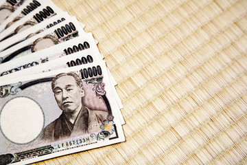 Japanese yen notes on tatami background