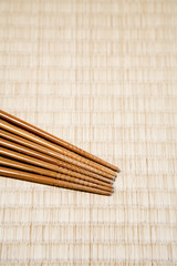 Chopsticks isolated on tatami mat background