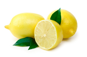 Three ripe lemons with sheet on white background