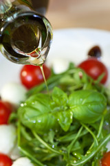 Olive Oil Dressing Pouring Onto Fresh Salad