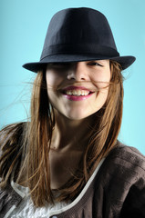young woman smiling with black hat