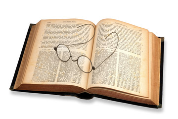 Old book with glasses