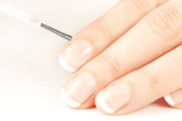 Obraz na płótnie Canvas Manicurist applying natural looking nail polish