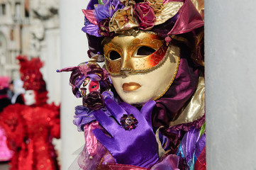 impressive purple beautiful gold mask at the carnival in Venice