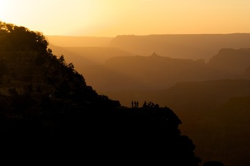 People on Bluff Amid Silhouetted Hills