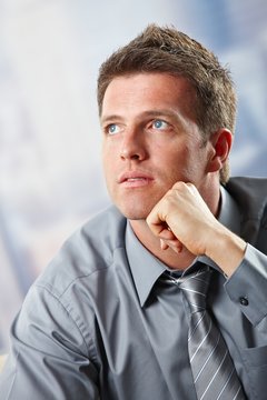 Portrait of businessman looking up thinking