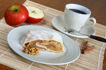 cup of coffee in white porcelain with apple strudel