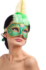Portrait of beautiful woman wearing green carnival mask