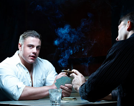 Two gamblers smoking and drinking