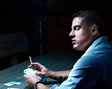 Young handsome gambler with cigar