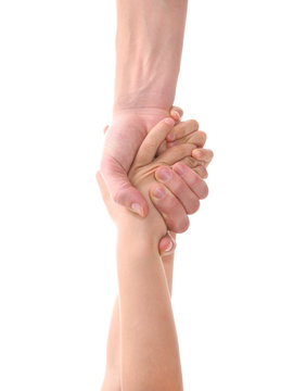 big adult's hand pulling small child's hand to help
