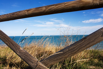 Wooden railing that overlooks the sea
