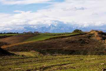 countryside and snowy mountains