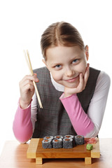 Little girl eating sushi