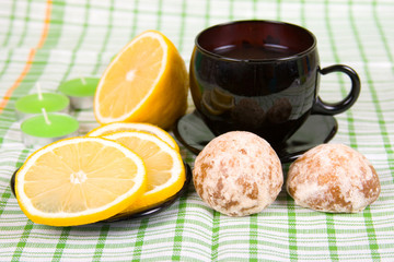 Cup of tea, lemon and a dessert