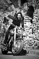 Fototapeta na wymiar The young girl on a motorcycle something shouts