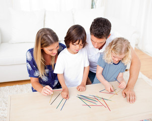Loving family playing mikado in the living room