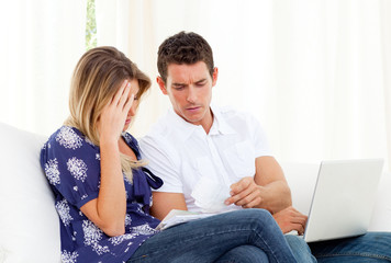 Distressed couple angry with so many bills to pay