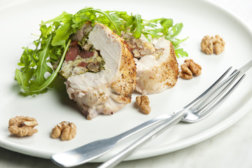 pork roll filled with sausages, eggs, almonds and ruccola