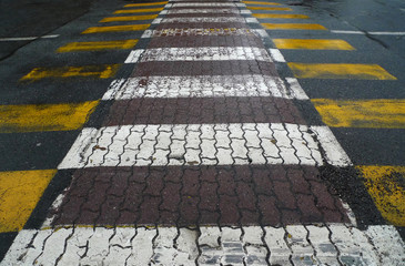 yellow and white stripes walking in city