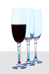 Three wine glasses, one with wine