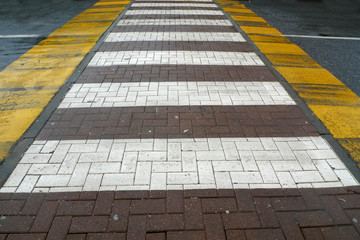 yellow and white stripes walking in city