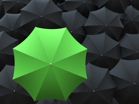 One green and many black umbrellas