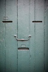 Wooden door with slots as an human face
