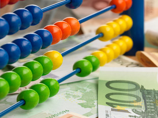 Close up of a colored children Abacus on money fond