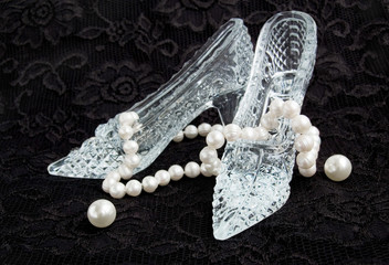 Glass slippers with pearls on a black lace