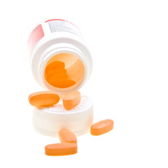 Close-up bottle of yellow pills isolated on white