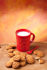 Red cup of milk and cookies. Copyspace above.