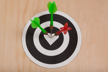 Three colour darts hit the target whang in the heart
