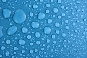 Blue water drops background with big and small drops
