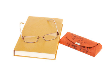 glasses,  book and carrying case for glasses isolated on white