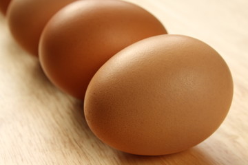 Eggs in a row on a wooden table