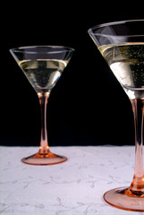 two wineglasses on white tablecloth