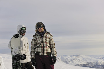 Fototapeta na wymiar snowboarder's couple on mountain's top