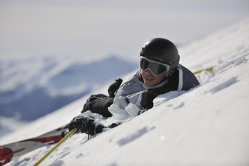 young skier relaxing at beautiful sunny winter day
