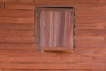 Naklejka na ściany i meble Holzwand mit Holzfenster