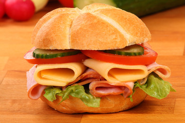 Crusty white roll filled with ham and salad