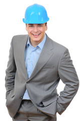 engineer with blue hard hat standing confidently