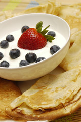 Pancakes with sour cream and fruits