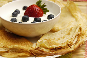 Pancakes with sour cream and fruits