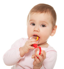 Little girl sucking toy