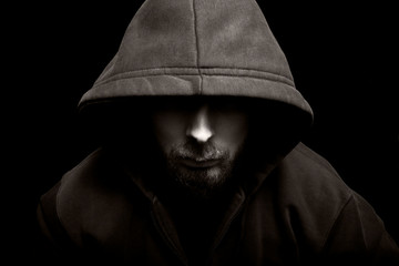 Scary evil man with hood in the dark - obrazy, fototapety, plakaty