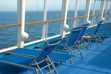 Blue Lounge chairs on deck of cruise ship